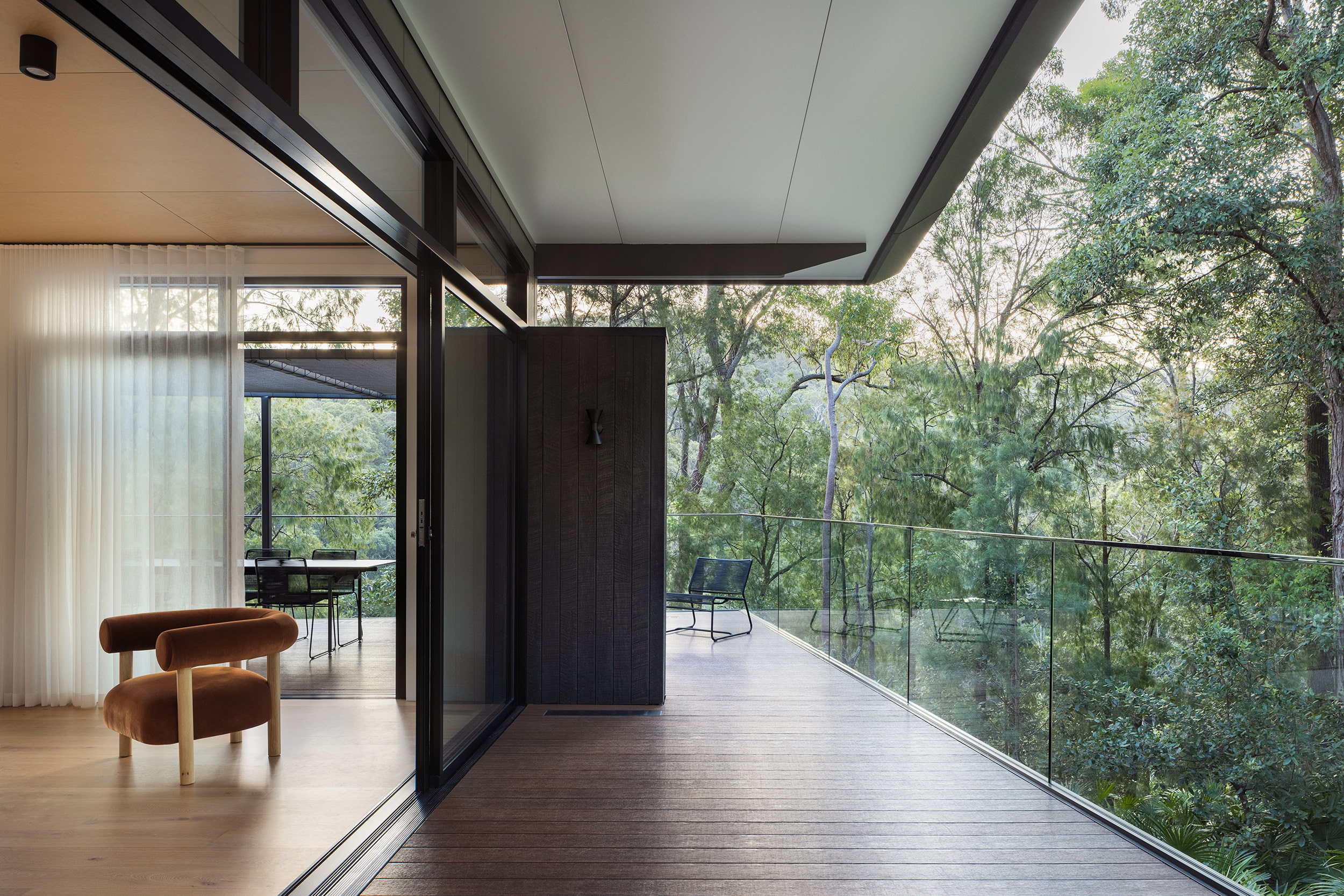 A natural looking deck bordered by trees