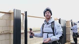 Professional carpenter with tool belt installing modern castellation cladding, demonstrating expertise in building exterior enhancements