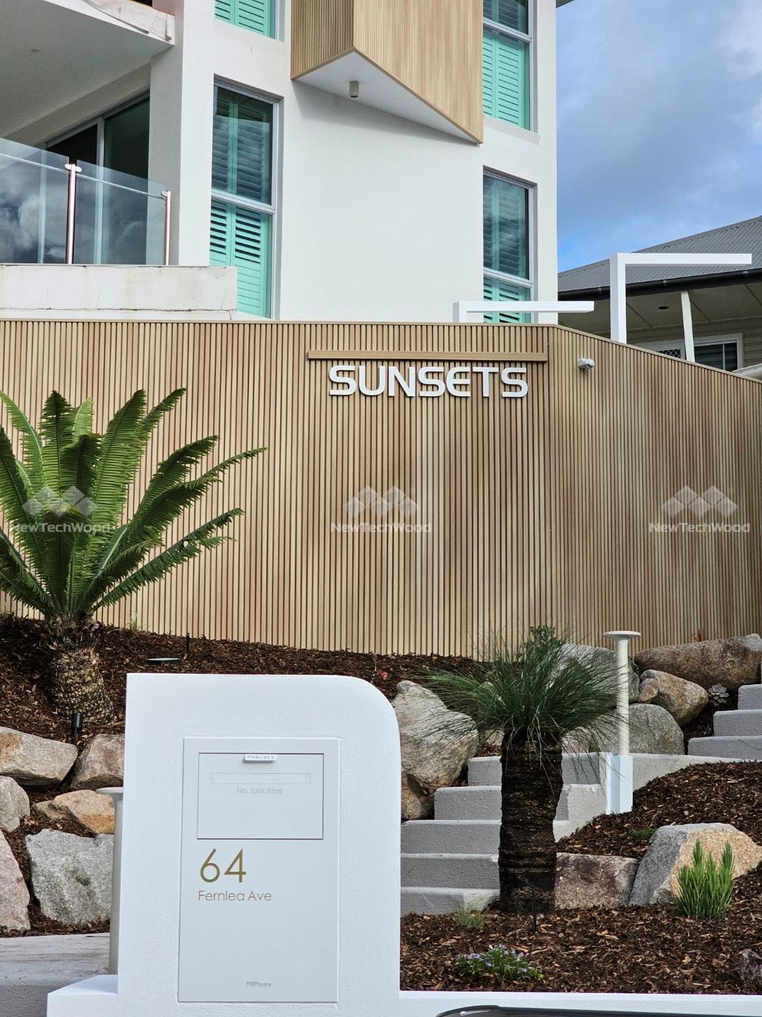 A contemporary home with vertical NewTechWood composite wall panels, enhancing the facade with natural textures and modern design.