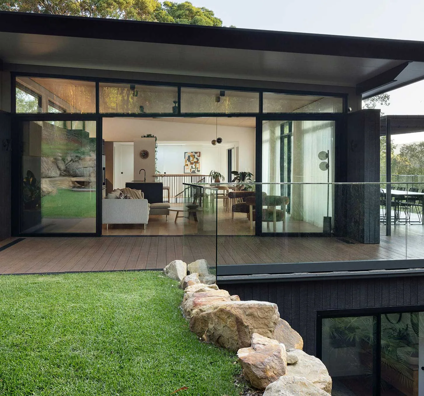 a black modern house with a deck